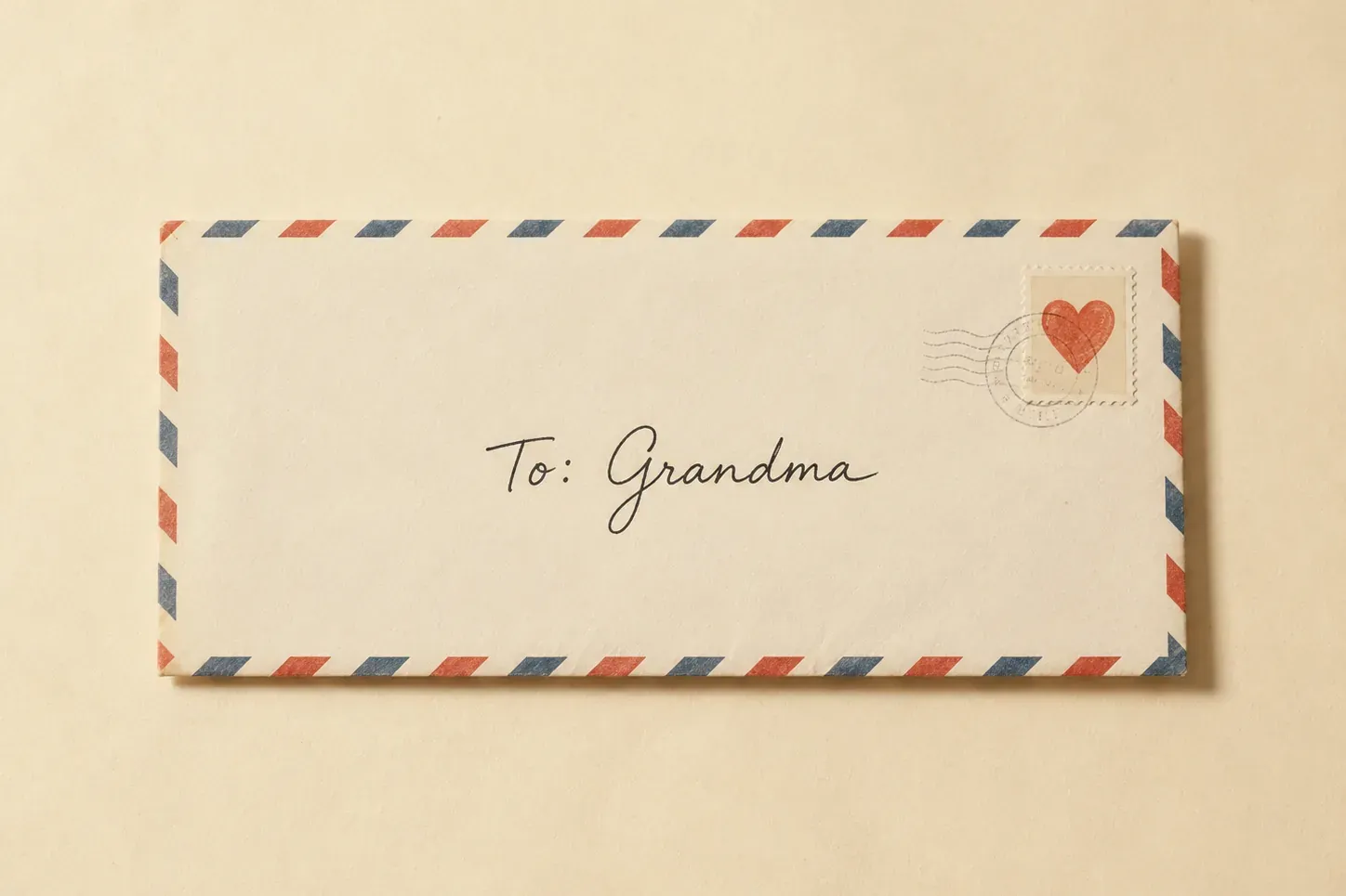 An airmail envelope addressed by hand to Grandma, with a heart stamp in the corner