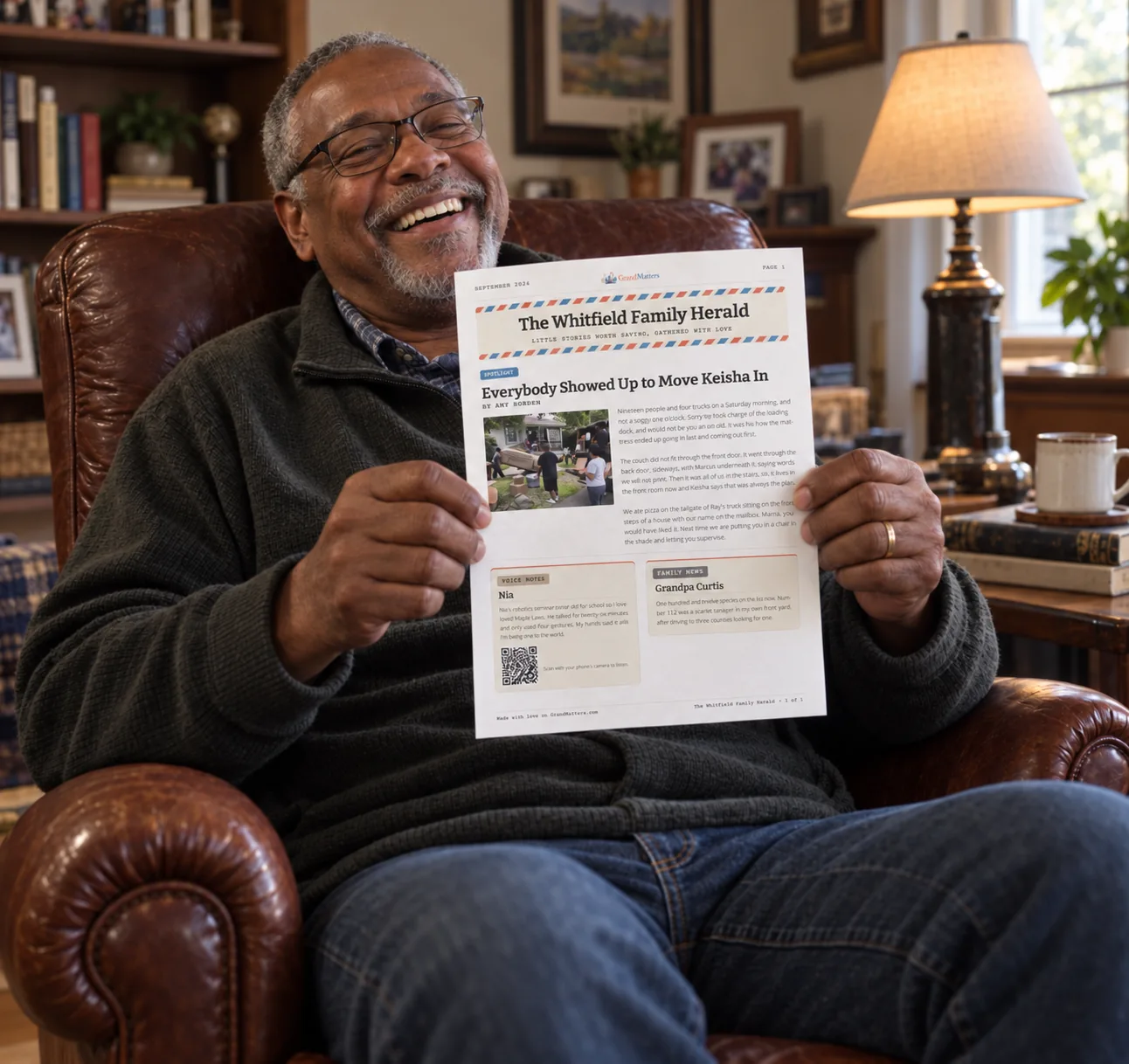 A grandfather laughing as he reads his family’s printed newsletter in his armchair